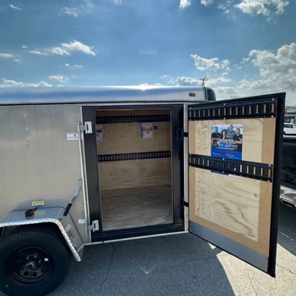 Side door of a cargo trailer open.