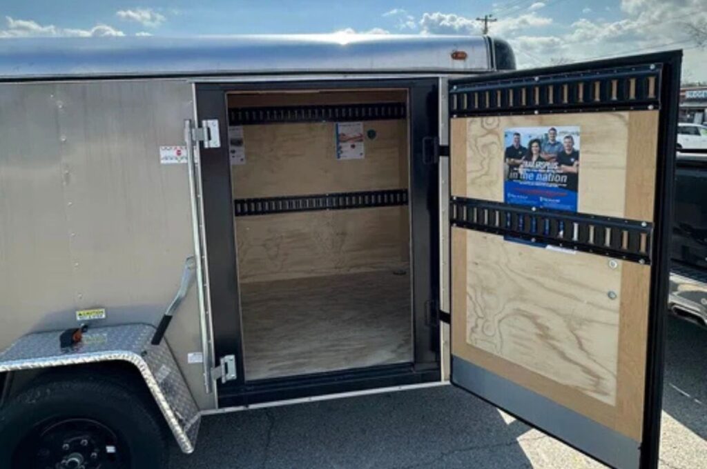 Side door of a cargo trailer open.