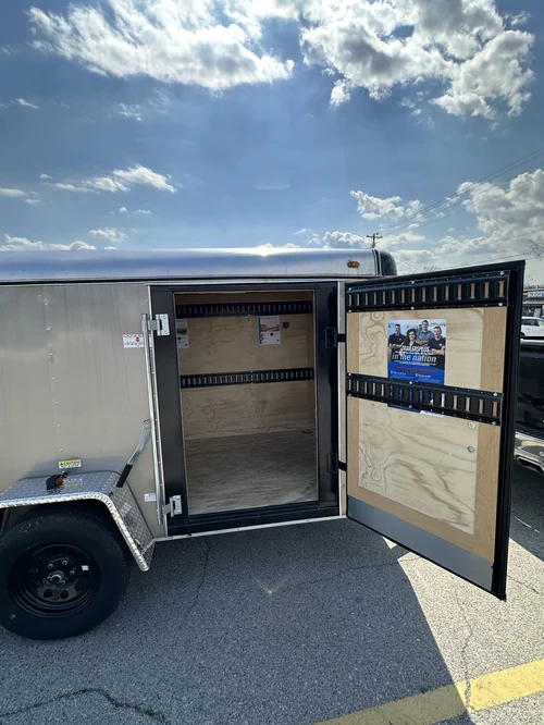 Open door touring trailer showcasing the inside of the unit