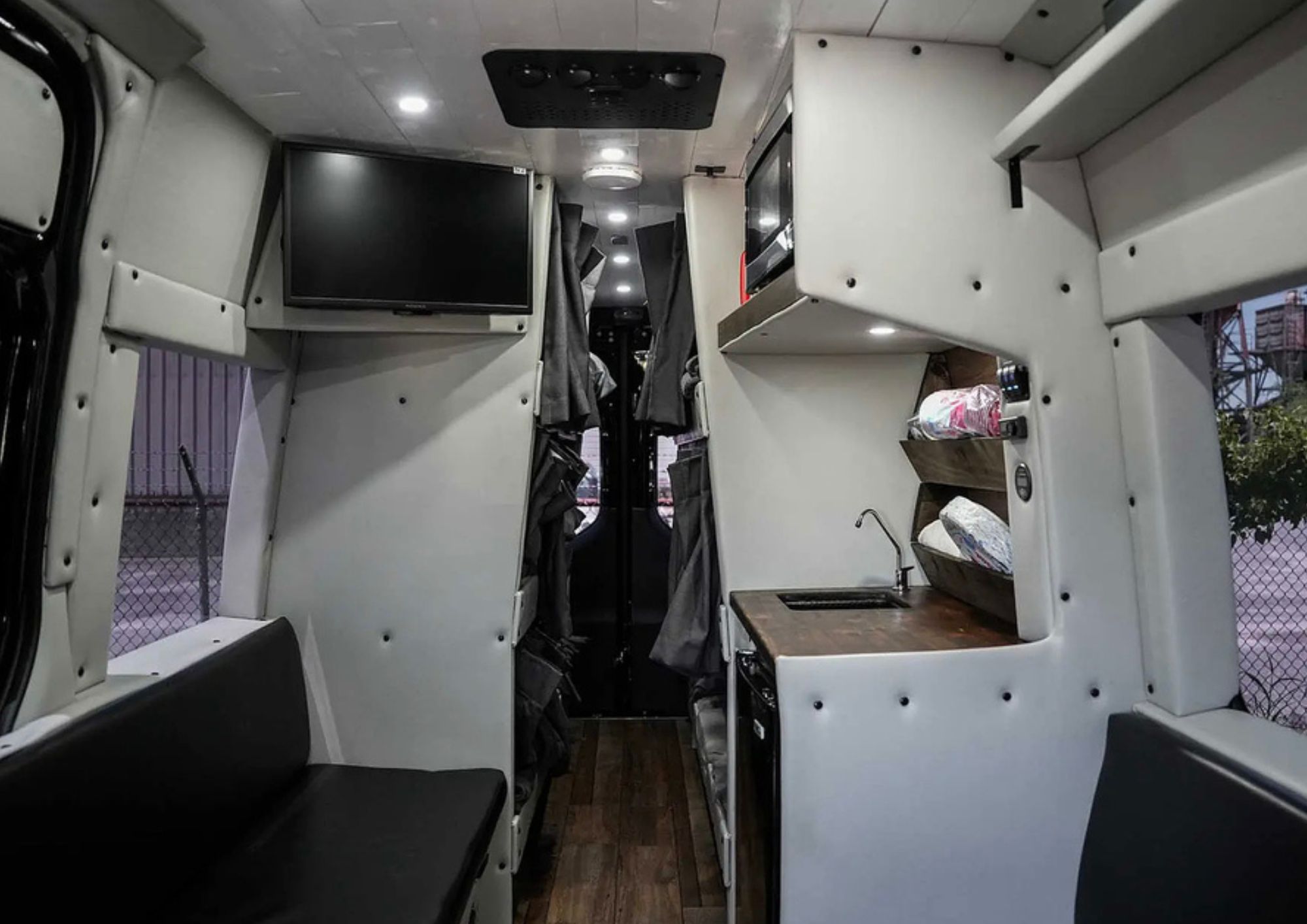 Wide interior view of custom camper van layout.